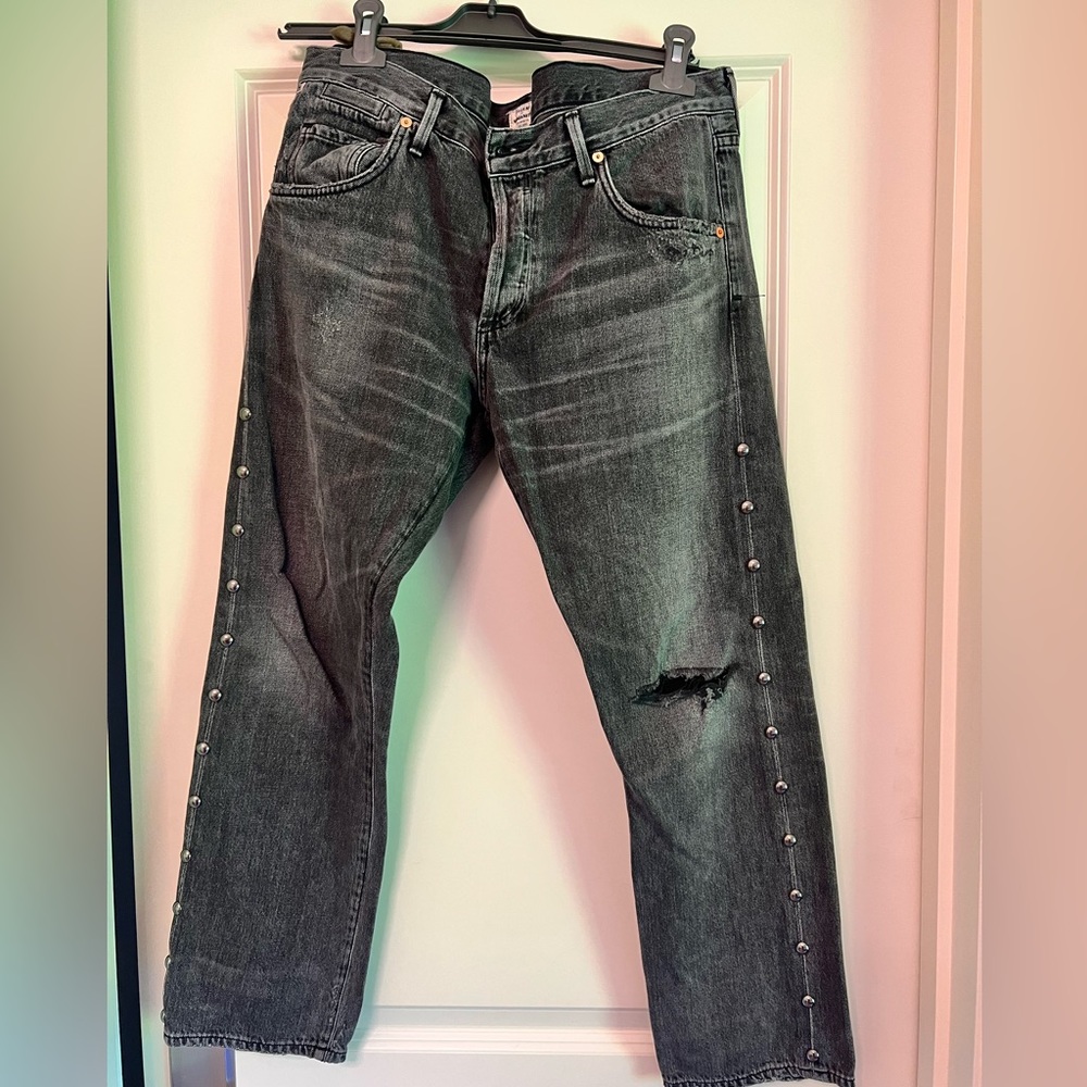 Grey jeans with studs.